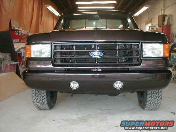 Dark brown 1991 Ford F-150 front view with chrome grille and fog lights