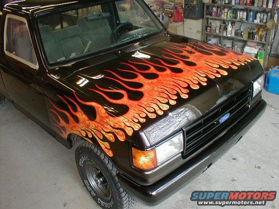 Black 1991 Ford F-150 with custom orange and red flame paint on hood and fender