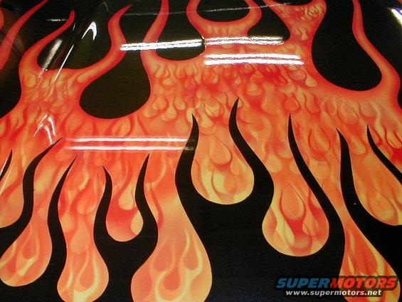Close-up of a black vehicle with orange and yellow flame graphics