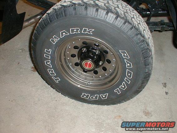 Close-up of a truck tire with 'TRAIL MARK' and 'RADIAL' written on the sidewall
