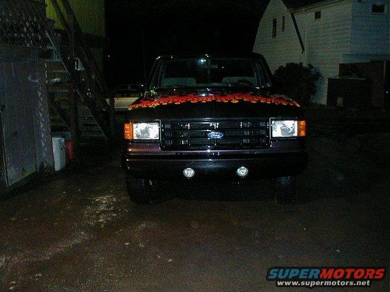 Black 1991 Ford F-150 front view with orange flames on hood