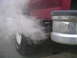 1994 Ford Bronco - Thick exhaust smoke is exiting the tailpipe of a vehicle.