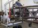 1994 Ford Bronco - A custom tube chassis is shown with an engine and transmission being worked on in a garage setting.