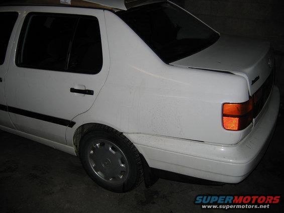 White sedan rear quarter view