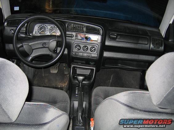 Volkswagen Golf interior with steering wheel, dashboard, and seats visible. Radio slot is empty