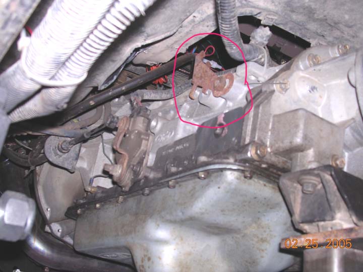 shifterbracketlocation.jpg the bronco came with a hole in the floor, but no where to mount a shift lever.  This piece of metal apparently serves no purpose, so I removed it and relaized there were two threaded holes instead of just one.