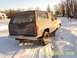 1985 Ford Bronco - A 1985 Ford Bronco struggles for traction in a snowy environment, emitting exhaust smoke.
