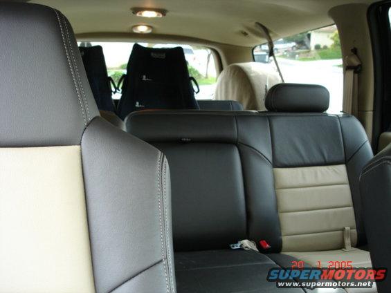 Interior rear seats of a 2005 Ford Excursion, showing two-tone leather upholstery and headrests