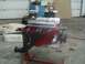 1981 Chevrolet C/K Pickup - A red V8 engine with chrome valve covers and black headers is displayed on a stand in a garage setting.
