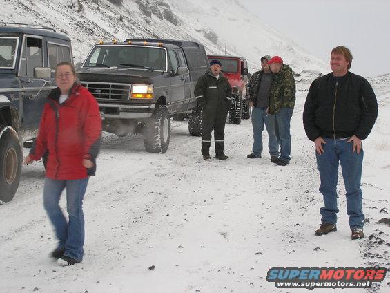 Group of people with off-road vehicles in a snowy landscape