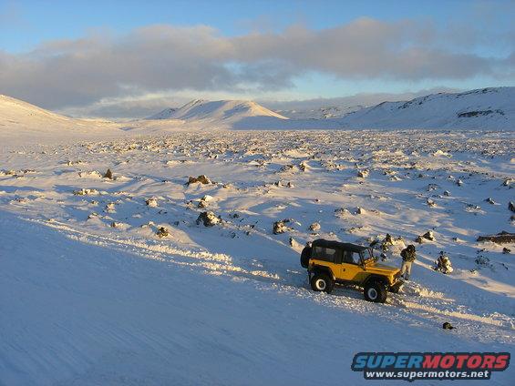 Yellow 2001 Jeep TJ in snowy landscape