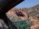 2004 Aston Martin Virage - Off-road vehicles tackle a challenging, rocky incline under a clear blue sky.
