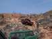 2004 Aston Martin Virage - Two off-road vehicles navigate a steep, rocky terrain under a clear blue sky.