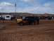 2004 Aston Martin Virage - A modified Ford Bronco with custom paint sits on a sandy track, surrounded by spectators and trailers.