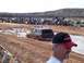 2004 Aston Martin Virage - A Ford Bronco navigates a muddy track during a competition, with a crowd gathered to watch.