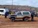 2004 Aston Martin Virage - A two-tone SUV is seen in a muddy area with spectators observing the scene.