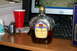 1989 Ford Bronco - Desk setup includes a bottle of Crown Royal, a red cup, and a digital camera.