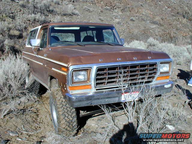 Brown 1978 Ford Bronco front 3/4 view, off-roading in dry brush