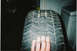 2000 Ford Crown Victoria - A tire is shown in detail, with a hand providing a sense of its size.