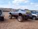 2004 Aston Martin Virage - Modified 1970s Chevrolet Camaro built for mud bogging, seen with other vehicles in a sandy area.