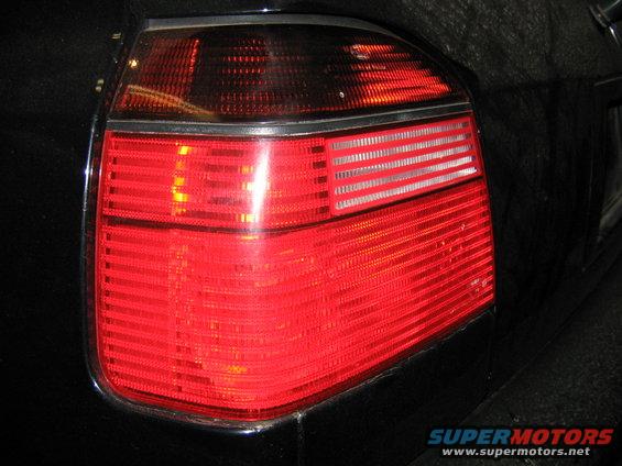 Close-up of a car's red taillight with horizontal lines