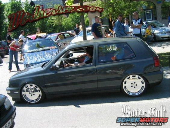 Dark gray hatchback with custom wheels, side view. Registry claims 1990 Jeep YJ