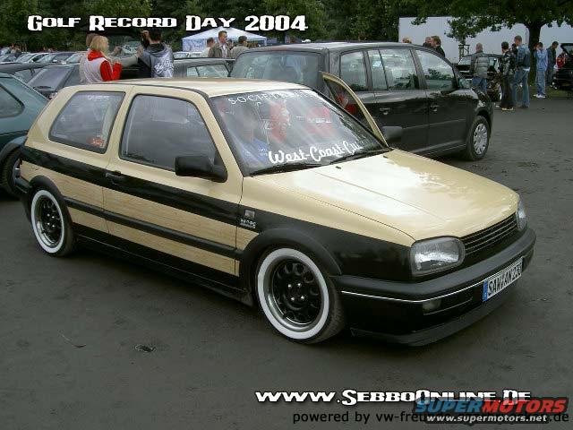 Volkswagen Golf Mk3 with wood paneling and white wall tires. Text on windshield reads 'West-Coast-Customs'