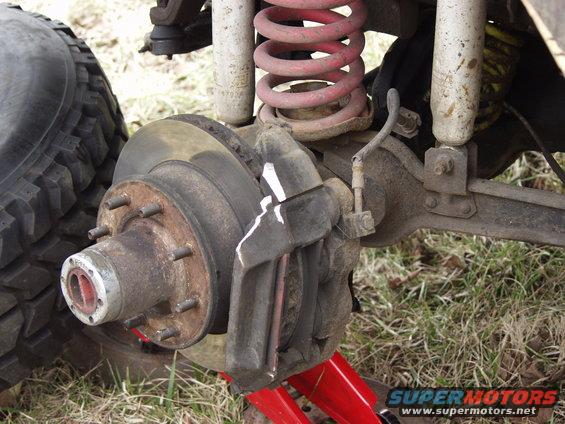 Front wheel brake assembly with red coil spring and white shock absorber