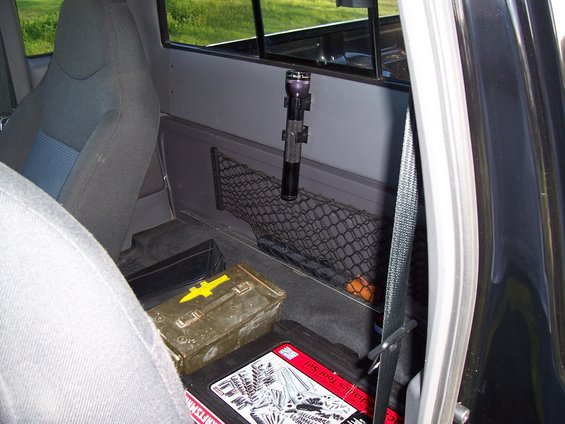 2003 Ford Ranger interior showing passenger seat, toolboxes, and a flashlight mounted on the cab wall