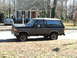 1996 Ford Bronco - A two-tone Ford Bronco is parked in front of a house with a blue sedan in the background.