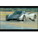 Silver sports car with a low profile and wide stance, seen from a 3/4 front angle on a wet surface
