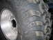 1978 Ford Bronco - A close-up view of a off-road tire mounted on a shiny aluminum wheel, showing its deep tread blocks.