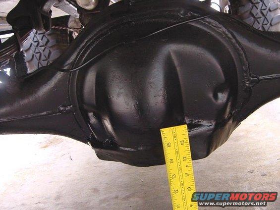 Rear differential housing with a yellow ruler measuring its width
