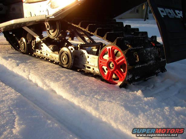 Red wheel on snowmobile track and suspension. 2003 Polaris 600 PRO X