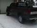 1981 Chevrolet C/K Pickup - A dark red pickup truck is parked in the snow, a humorous sticker on its rear window.