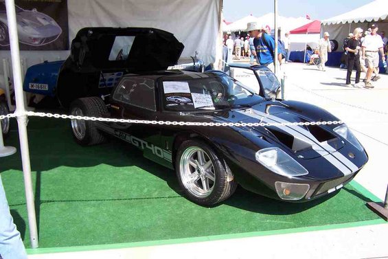 Black Ford GT40 with silver stripes, doors open, on display