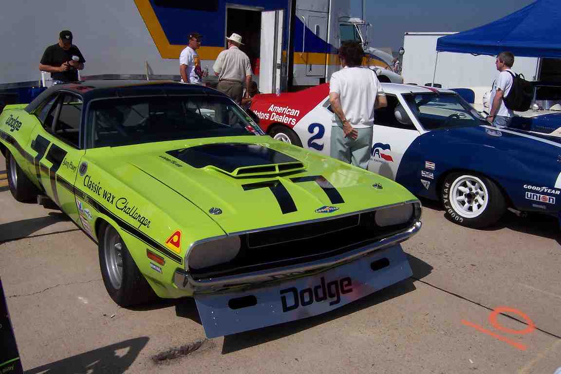 Lime green Dodge Challenger with black racing stripes and number 77