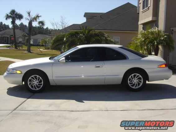 Side view of a white 1997 Lincoln Mark VIII parked in a driveway