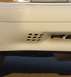 1993 Ford Mustang - Close-up of a white vehicle's front bumper, revealing distinctive grille patterns.