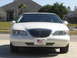1997 Lincoln Mark VIII - The front grille and headlights of a white Lincoln Mark VIII are visible.