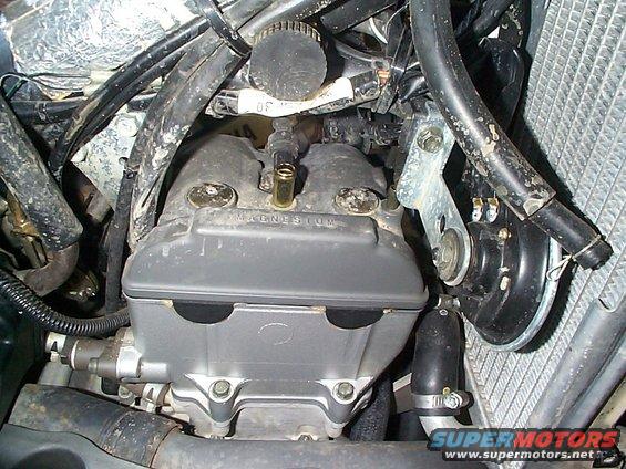 Close-up of motorcycle engine valve cover with 'MAGNESIUM' visible