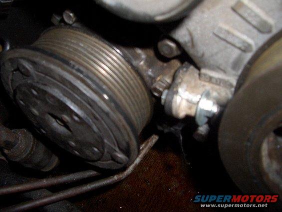 Close-up of a ribbed pulley and part of an engine block