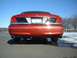 1999 Ford Crown Victoria - Rear view of a red Ford Crown Victoria with a black accent panel and chrome trim.