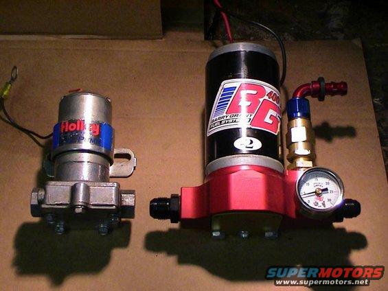 Holley and Barry Grant fuel pumps side-by-side, one with a pressure gauge