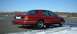 1999 Ford Crown Victoria - A red sedan is viewed from the rear quarter angle on a cold day.