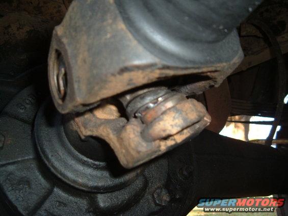 Rusty driveshaft universal joint with visible wear on the bearing cap