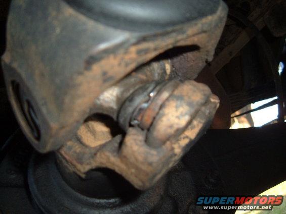 Driveshaft universal joint with rust and wear, close-up view