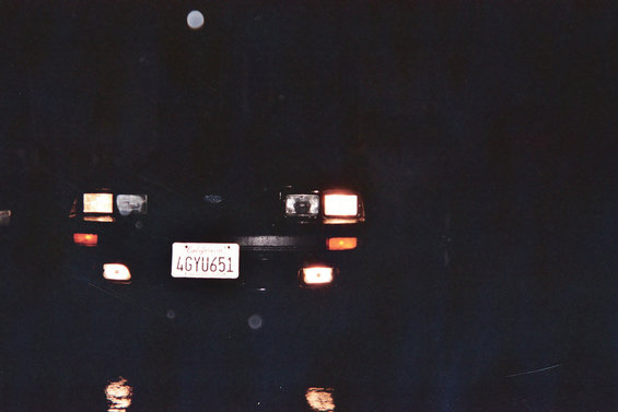Car's rear with license plate 4GYU651 visible. Lights are on