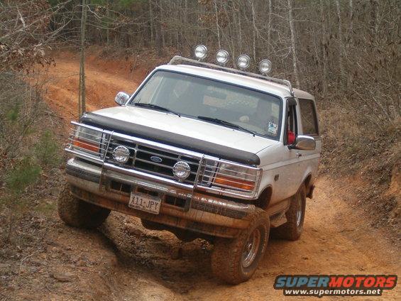 White 1996 Ford Bronco on a dirt trail