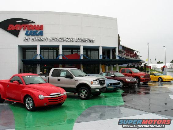 Several cars and trucks parked outside the Daytona USA attraction